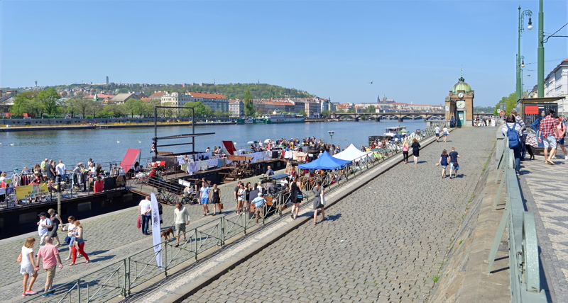 26 - The vibrant Náplavka riverbank along the Vltava River in Prague, famous for its weekend farmers' markets, moored cultural boats, and lively social atmosphere